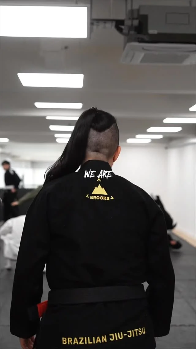 Student wearing Brooks BJJ black kimono
